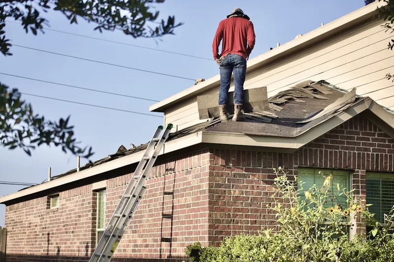 Professional roofer working on a residential roof in Rose Valley